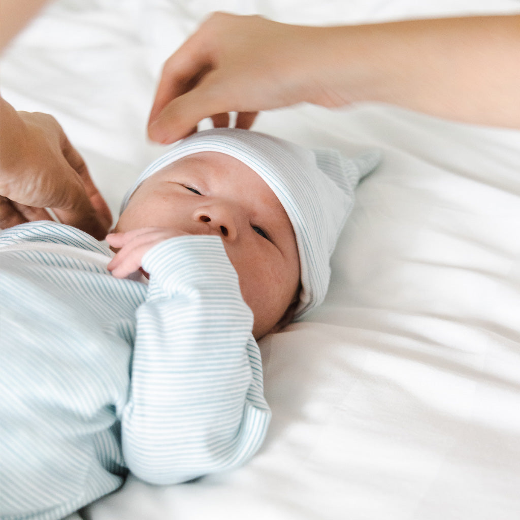 Motherswork x Le Petit Society Baby Organic Knotted Hat in Blue Stripes